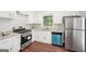 Bright kitchen with white cabinets, stainless steel appliances, and wood flooring at 1120 Starline Dr, Smyrna, GA 30080
