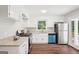 Bright kitchen with white cabinets, stainless steel appliances, and wood flooring at 1120 Starline Dr, Smyrna, GA 30080