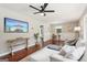 Spacious living room with modern lighting, hardwood floors, and cozy seating arrangement with a view of a flat screen tv at 1120 Starline Dr, Smyrna, GA 30080