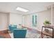 Bright living room featuring hardwood floors, blue armchairs, and a modern area rug at 1120 Starline Dr, Smyrna, GA 30080