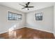 Neutral bedroom featuring hardwood floors, fresh gray paint, a ceiling fan, and natural light from two windows at 1120 Starline Dr, Smyrna, GA 30080
