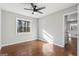Neutral bedroom featuring hardwood floors, fresh gray paint, a ceiling fan, and natural light from a window at 1120 Starline Dr, Smyrna, GA 30080