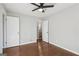 Neutral bedroom featuring hardwood floors, fresh gray paint, a ceiling fan, and two closets at 1120 Starline Dr, Smyrna, GA 30080