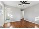 Bedroom features hardwood floors, ceiling fan, and a view to an ensuite bathroom at 1120 Starline Dr, Smyrna, GA 30080