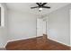 Neutral bedroom featuring hardwood floors, fresh gray paint, a ceiling fan, and access to an ensuite at 1120 Starline Dr, Smyrna, GA 30080
