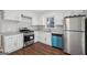 Eat-in kitchen with white cabinets, stainless steel appliances, and durable laminate flooring at 1120 Starline Dr, Smyrna, GA 30080