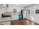 Eat-in kitchen with white cabinets, stainless steel appliances, and durable laminate flooring at 1120 Starline Dr, Smyrna, GA 30080