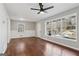 Bright living room with hardwood floors, large windows, and a modern ceiling fan at 1120 Starline Dr, Smyrna, GA 30080