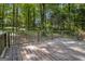 Wooden back deck featuring weathered wood and view of the wooded property at 20 King Pl, Stockbridge, GA 30281