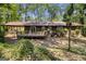 Back of home featuring wooden deck, siding, covered porch, and wooded backyard at 20 King Pl, Stockbridge, GA 30281