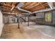 Unfinished basement featuring concrete flooring, wooden support beams, and window at 20 King Pl, Stockbridge, GA 30281