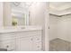 Bathroom vanity featuring quartz counters and white cabinets with an entry to a walk-in closet at 20 King Pl, Stockbridge, GA 30281