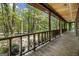 Inviting and spacious covered front porch overlooking mature landscaping and natural surroundings at 20 King Pl, Stockbridge, GA 30281