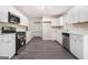 Modern kitchen featuring stainless steel appliances, white cabinets, and new vinyl flooring at 20 King Pl, Stockbridge, GA 30281