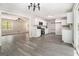 Open kitchen featuring white cabinets, stainless steel appliances, and grey laminate flooring at 20 King Pl, Stockbridge, GA 30281