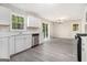 Bright kitchen with stainless steel appliances, white cabinetry, and sliding door access to backyard at 20 King Pl, Stockbridge, GA 30281