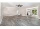 Large living room featuring new vinyl floors, ceiling fan, and open access to the kitchen at 20 King Pl, Stockbridge, GA 30281