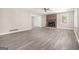 Cozy living room featuring new vinyl flooring, brick fireplace, and open access to other rooms at 20 King Pl, Stockbridge, GA 30281