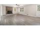 Inviting living room with brick fireplace, ceiling fan, new vinyl flooring and natural light at 20 King Pl, Stockbridge, GA 30281