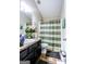 Well-maintained bathroom with decorative shower curtain and vanity storage at 386 Hill Crest Cir, Hiram, GA 30141