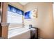 Bathroom showcasing a soaking tub with natural light and decorative accents at 386 Hill Crest Cir, Hiram, GA 30141