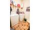 Functional laundry room featuring a washer, dryer, and ample shelving for storage at 386 Hill Crest Cir, Hiram, GA 30141