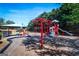 Community playground featuring play structures, swings, and a covered play area on a sunny day at 386 Hill Crest Cir, Hiram, GA 30141