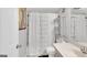 Clean bathroom features a shower-tub combo with stylish curtain and shelving for organized storage at 93 Rue Fontaine, Lithonia, GA 30038