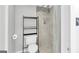Clean bathroom featuring a toilet, shower with tile surround, and storage shelves at 93 Rue Fontaine, Lithonia, GA 30038