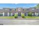 Traditional-style townhome with a meticulously maintained lawn and welcoming double-door entryway at 93 Rue Fontaine, Lithonia, GA 30038