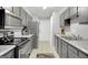 Well-lit kitchen with stainless steel appliances, gray cabinetry, and ample counter space at 93 Rue Fontaine, Lithonia, GA 30038