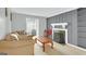 Cozy living room featuring a comfortable sofa, fireplace, and access to a bright, enclosed sunroom at 93 Rue Fontaine, Lithonia, GA 30038