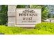 Fontaine West: an HOA community sign surrounded by vibrant greenery, establishing a welcoming neighborhood at 93 Rue Fontaine, Lithonia, GA 30038