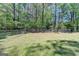Fenced-in backyard with a well-maintained lawn and mature trees, offering a secure outdoor space at 4735 Rabbit Farm Rd, Loganville, GA 30052