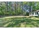 Expansive backyard with healthy lawn, bordered by a chain-link fence and mature trees at 4735 Rabbit Farm Rd, Loganville, GA 30052