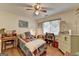 Cozy bedroom featuring hardwood floors, a ceiling fan, and natural light from the window at 4735 Rabbit Farm Rd, Loganville, GA 30052