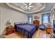 Spacious bedroom boasts a tray ceiling, hardwood floors, and natural light at 4735 Rabbit Farm Rd, Loganville, GA 30052