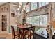 Charming breakfast nook boasts hardwood floors, a ceiling fan, and ample natural light, ideal for morning meals at 4735 Rabbit Farm Rd, Loganville, GA 30052