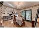 Dining room features hardwood floors, a chandelier, and access to other living spaces and a back patio at 4735 Rabbit Farm Rd, Loganville, GA 30052