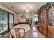 Dining room features hardwood floors, a chandelier, and a large wooden cabinet, creating an inviting atmosphere at 4735 Rabbit Farm Rd, Loganville, GA 30052