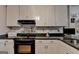 Cozy kitchen featuring a black oven and ample cabinet space at 4735 Rabbit Farm Rd, Loganville, GA 30052
