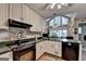 Bright kitchen with large windows and black appliances at 4735 Rabbit Farm Rd, Loganville, GA 30052
