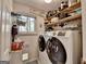 Well-organized laundry room with front-load washer and dryer at 4735 Rabbit Farm Rd, Loganville, GA 30052