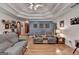 Bright living room featuring hardwood floors, a decorative ceiling, and comfortable seating under a ceiling fan at 4735 Rabbit Farm Rd, Loganville, GA 30052