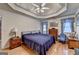 Spacious primary bedroom featuring hardwood floors, ceiling fan and plenty of natural light at 4735 Rabbit Farm Rd, Loganville, GA 30052