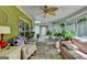 Bright sunroom featuring stone floors, large windows, comfortable seating, and stylish décor at 4735 Rabbit Farm Rd, Loganville, GA 30052