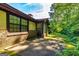 Backyard patio with lush green lawn and exterior of a brick home at 335 Jeff Davis Pl, Fayetteville, GA 30214