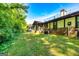 Backyard view with lush green lawn and exterior of a brick home at 335 Jeff Davis Pl, Fayetteville, GA 30214