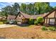 This home features Tudor-style architecture, a garage, and meticulously maintained landscaping at 335 Jeff Davis Pl, Fayetteville, GA 30214