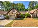 Charming home with Tudor-style accents, featuring a well-manicured lawn and attached garage at 335 Jeff Davis Pl, Fayetteville, GA 30214